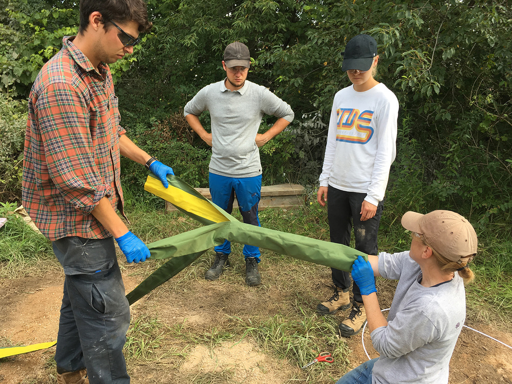 Working with a group of students in the field